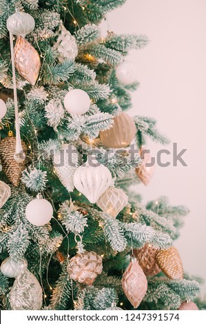 Blurred background. Luxury living room interior with sofa decorated chic Christmas tree, gifts, plaid and pillows.