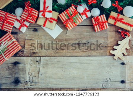 Christmas background with decorations and red gift boxes on the wooden board