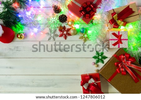 Gift boxes with Xmas tree on rustic wooden background, top view, copy space