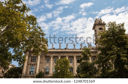 View from Liberty Square (Szabadság tér). Details of historical building emerging behind trees in the downtown area of Budapest, Hungary, Eastern Europe