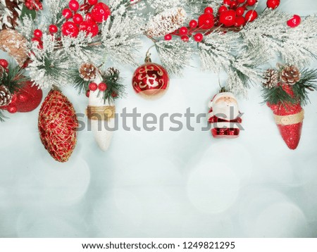 christmas decor with fir tree branch cones and snow on background with garland lights