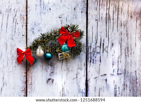 Green Christmas ornament with ball, bow and small gifts  on a wall background, xmas decoration