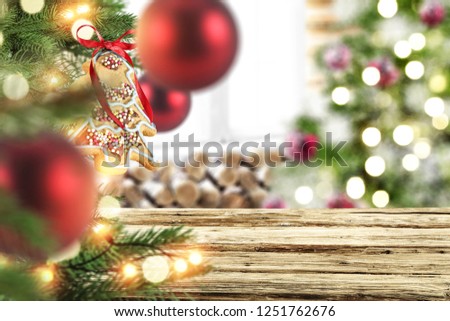 Table background of free space and christmas balls decoration on tree. 