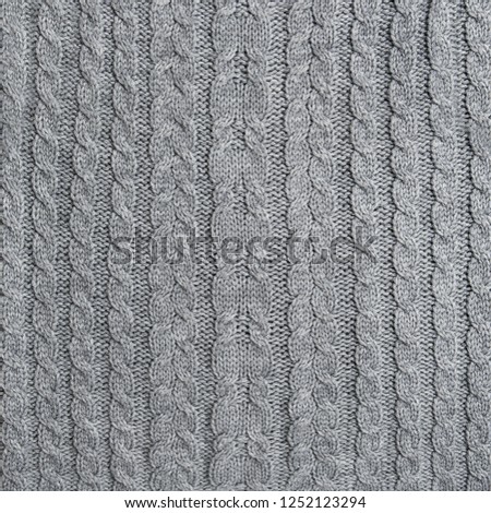 Knitted wool texture. Grey knit background. Knitting pattern