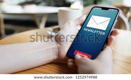 Newsletter subscription button on mobile phone screen. Business marketing concept.