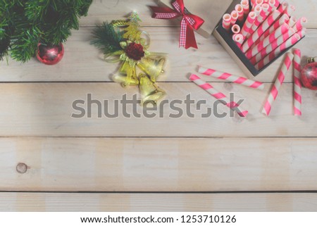 Top view of Wood Table party Christmas holidays consist of Golden bell, Pink candy, Gift box with ribbon, Green tree and copy space