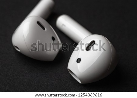 White wireless bluetooth earphones or headphones, macro photo close up