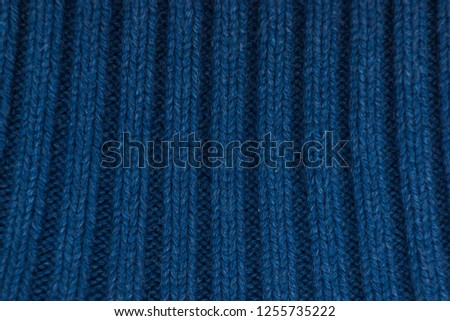 The blue texture of the knitted product.Warm, winter.