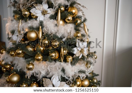 Gold Christmas background of de-focused lights with decorated tree