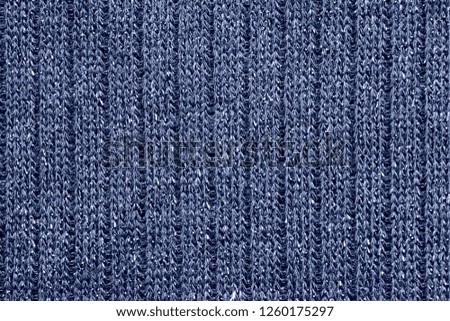 Dark blue knitted synthetic texture closeup