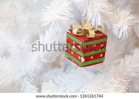 Red gift decorate on white Christmas tree