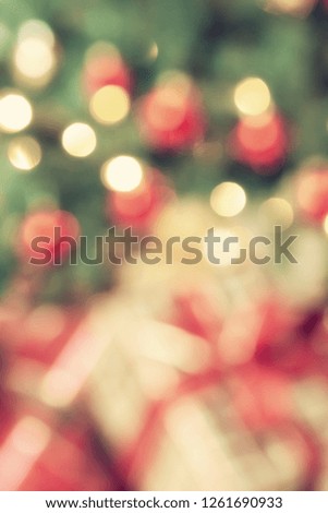 Out of focus holiday bokeh background. Christmas presents under the tree, close-up. Vintage filter effects.