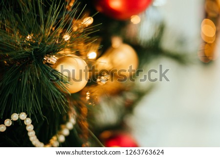 Background with Christmas tree decoration and gold garland.