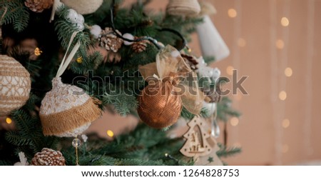 Christmas tree with toys and decorative snow for a happy new year on background of bokee.