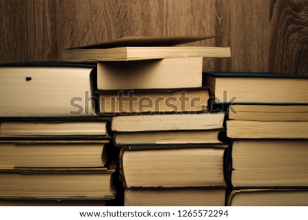pile of books on a wooden background