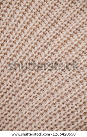 brown knitwear,texture of a woven piece of cloth made of a sweater


