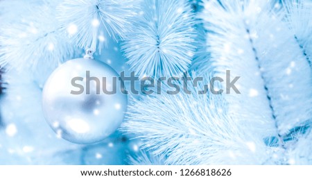 Close-up shots of a Christmas ball in a white Christmas tree and a snow background