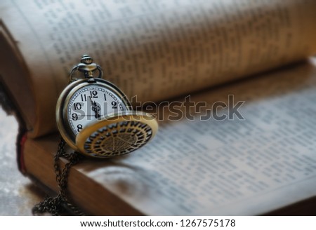 old book and pocket watch