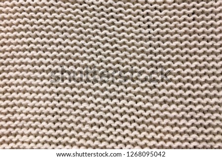 Knitted  sweater background. Knitted texture. A sample of knitting from merino wool. Knitting Pattern
