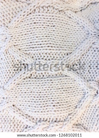 Sweater texture large knitting. Knitted jersey background with a relief pattern

