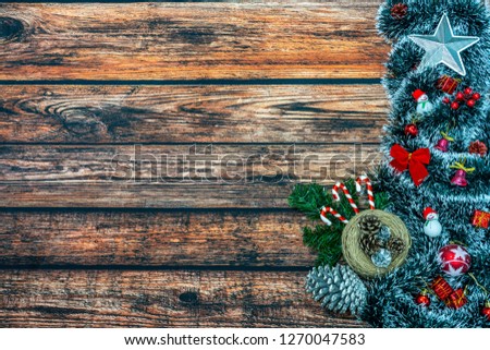 Christmas holiday background with gift boxes and decorations on wooden table. High angle view