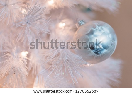 White ornament on white Christmas tree