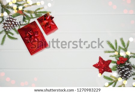 christmas background and decoration with fir branches gift boxes on white wooden board