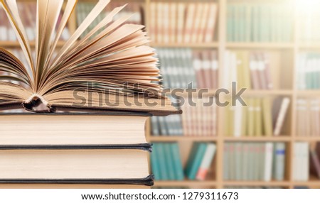 Old stacked books on background