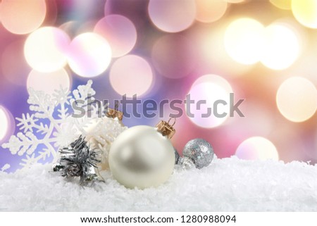 Silver christmas balls over snow isolated on white