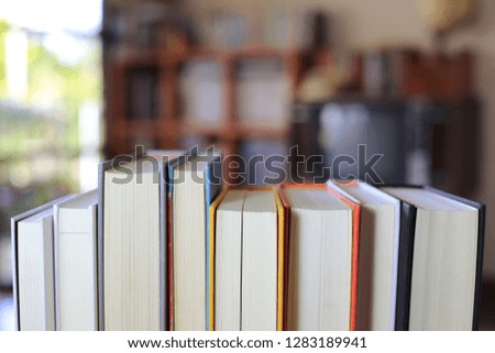 Close-up of several books arranged in rows in the library. Bookshelf is the background selective focus and shallow depth of field