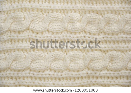 Stack of Warm knitwear close-up. Woolen knit texture as background