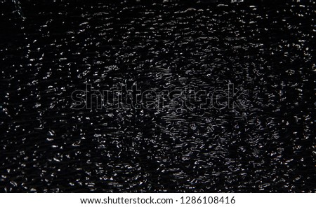 a silver-colored texture that reflects a black background