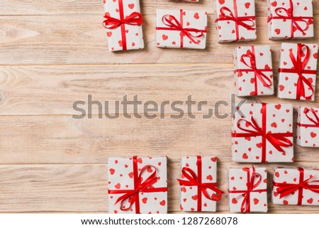 Valentine background - many valentine handmade present gift boxes on wooden background. top view with copy space. holiday concept.
