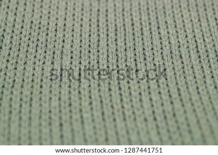Gray knitted texture. Fabric pattern from side