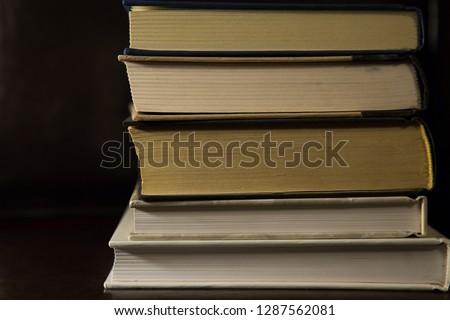 Stack of 5 books in various stages of wear 