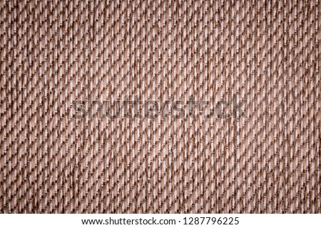 Textured background surface of textile upholstery furniture close-up. burlap brown color fabric structure