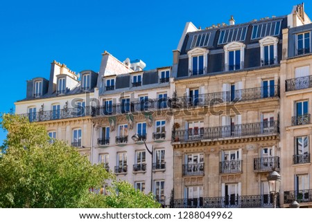     Paris, beautiful buildings boulevard de Clichy, typical parisian facades with sculptures on the stone 