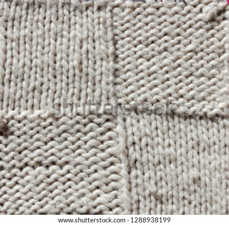 Texture of a knitted sweater made of white wool