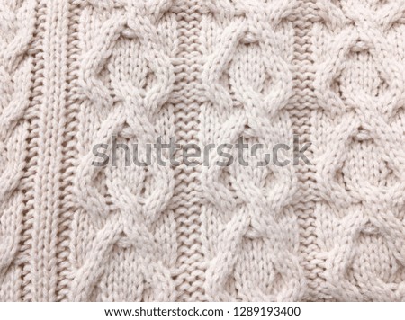 Knitted background. Knitted texture. A sample of knitting from wool. Knitting Pattern.


