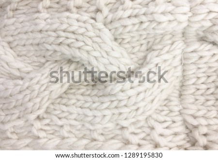 Wool sweater texture close up. Knitted jersey background with a relief pattern


