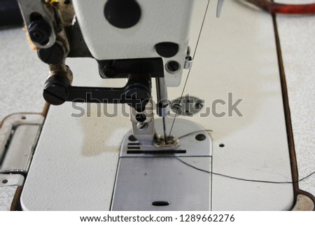 Sewing machine on table in tailor's workshop