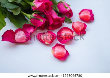 Roses and pink red hearts on a white background