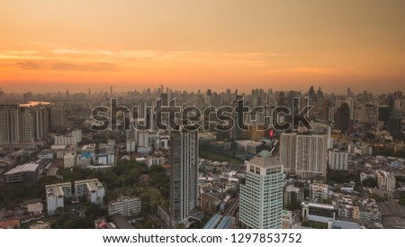 Business area in Bangkok, Thailand, showing buildings and traffic in sunset