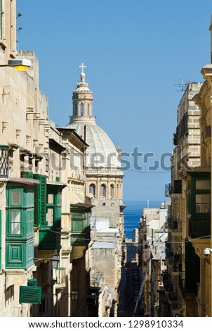 Street scene of buildings with green balconies in Valletta, Malta