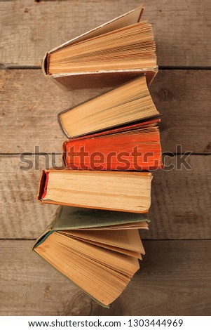 various old books on wooden background, concept of knowledge, leisure time, university still life
