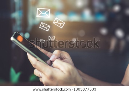 Woman hand using smartphone and it's show 1 email recieve notification icon pop up on screen of mobile phone. Business communication  technology concept.
