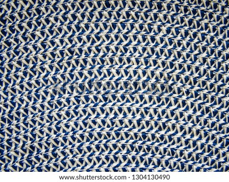 Pattern of interwoven white and blue threads. Texture. Background