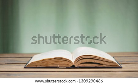 open book on the reflective surface of the table