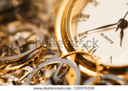 An old watch surrounded by clock gears.