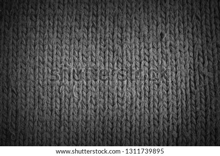 Dark grey knitted wool texture, vignetting effect